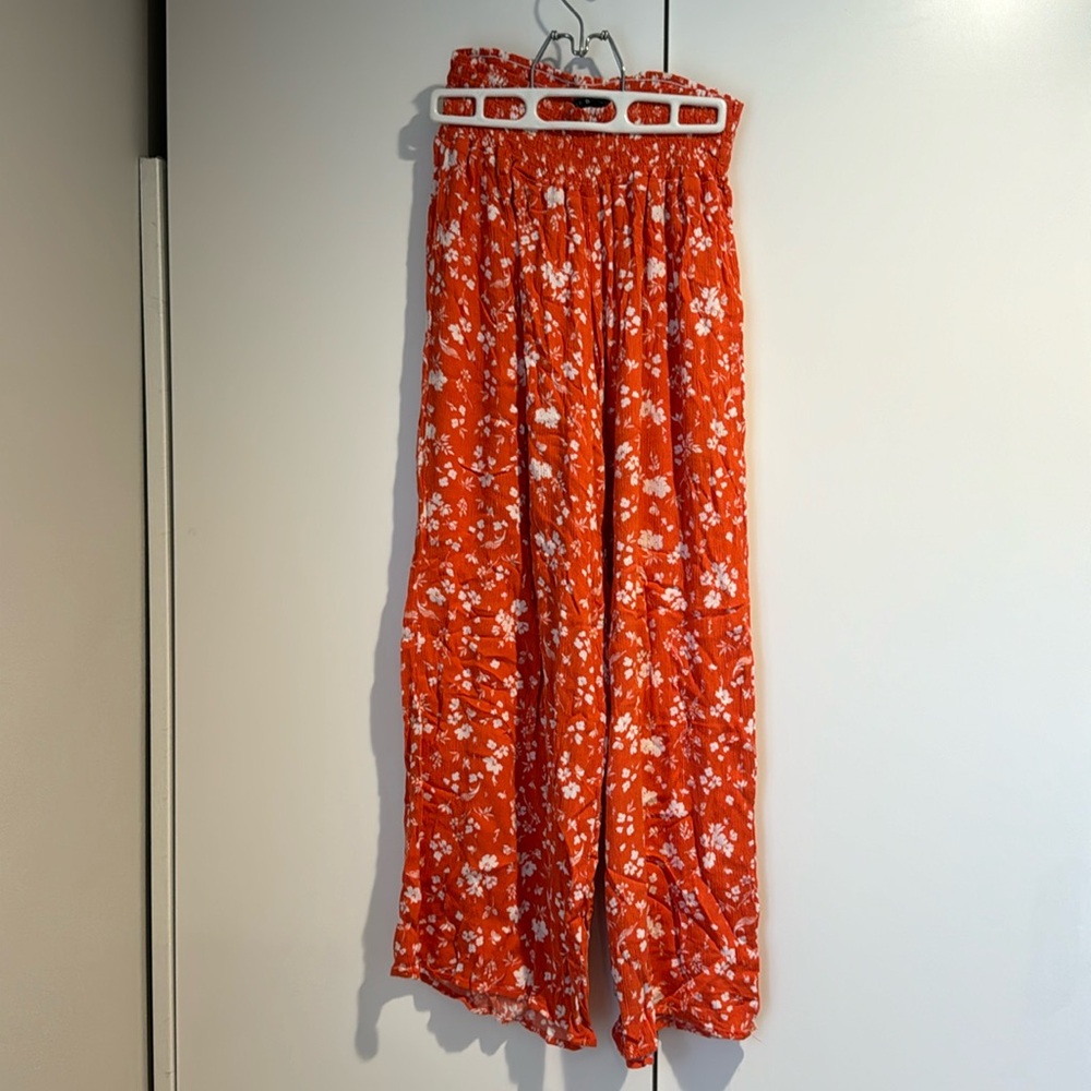 Orange wide leg gauzy pants.